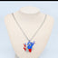 Necklace with a colorful pendant on a mannequin bust against a light blue background
