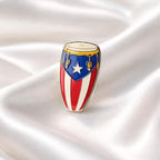 Decorative drum with Puerto Rican flag design on a white fabric background